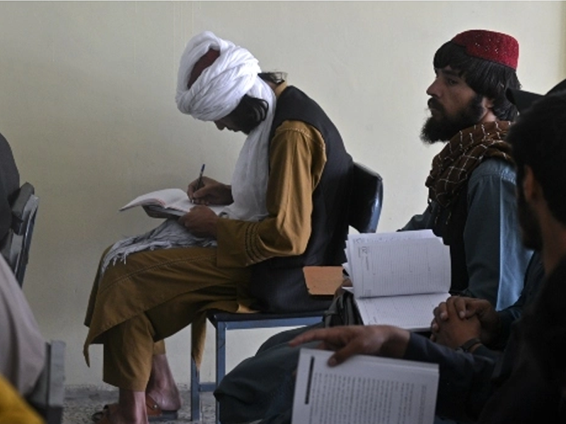 Taliban fighters swap arms for books as hundreds return to school